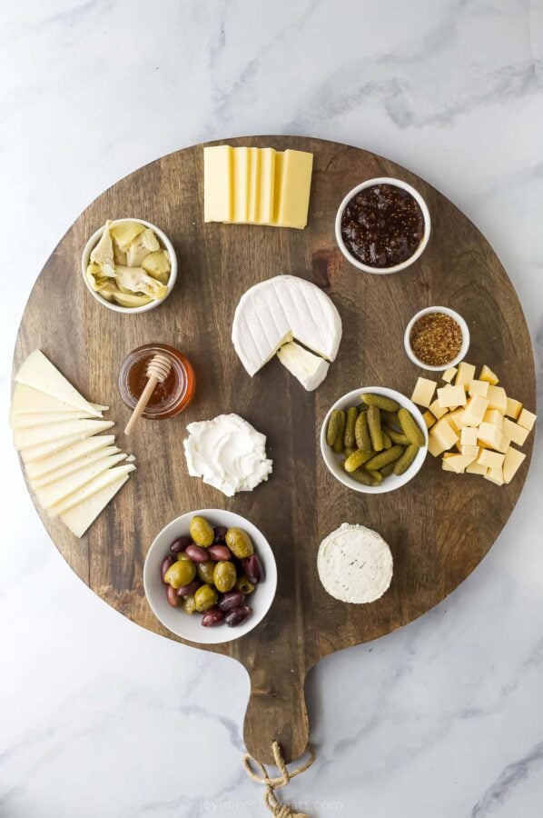 Overhead view of cheese and extras added to charcuterie board