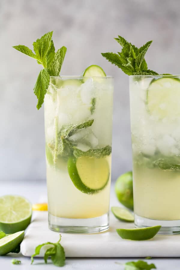 Two mojito mocktails in glasses with fresh mint sprigs for garnish
