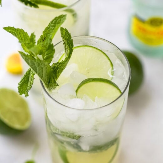 Two glasses of virgin mojito with lime wheels and mint sprigs