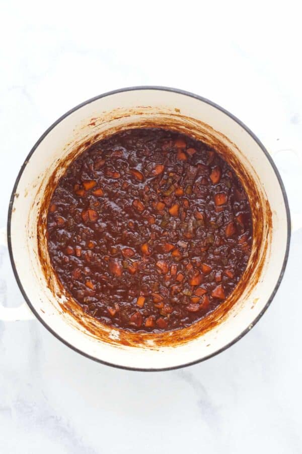 Overhead view of ragu in Dutch oven before adding short ribs