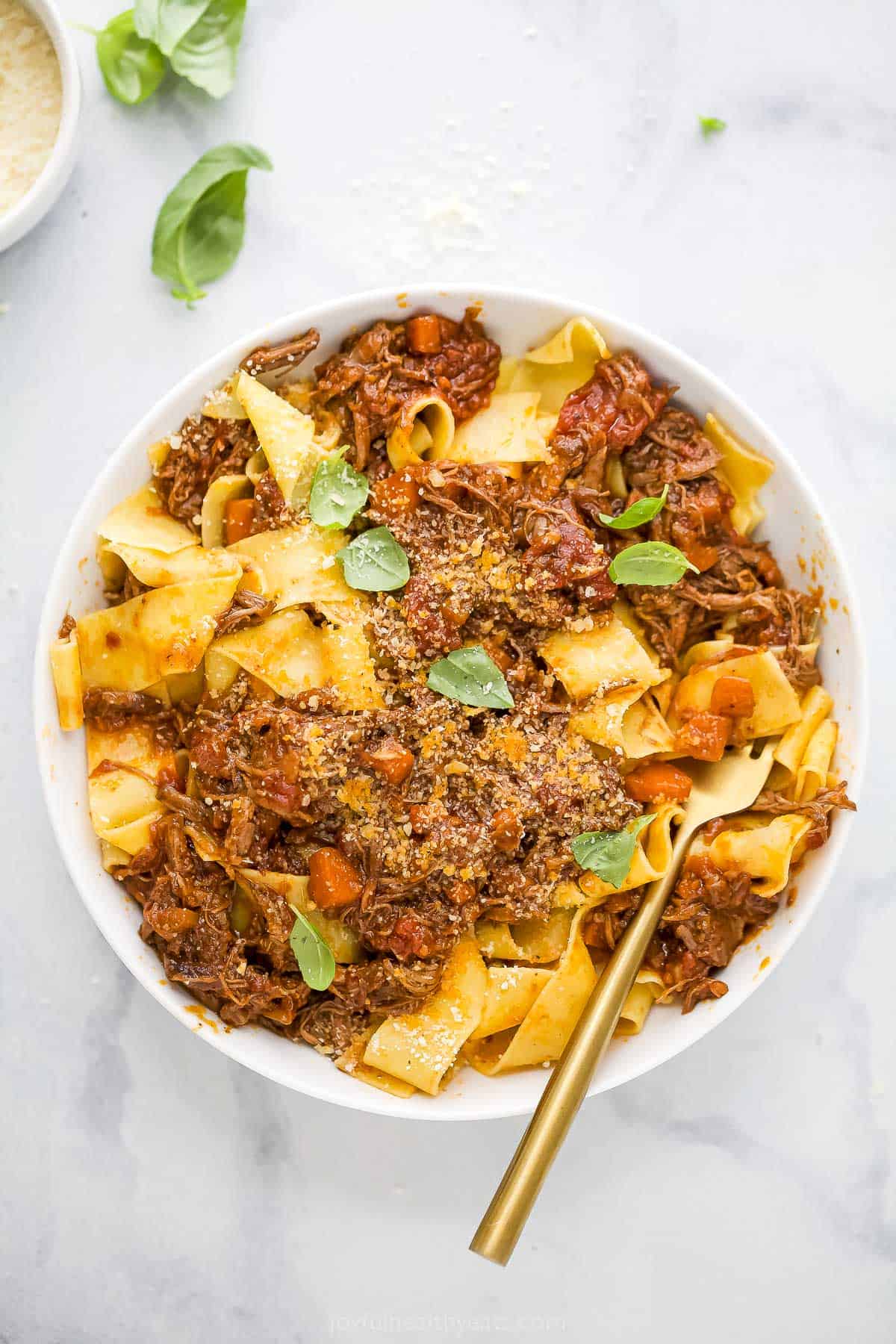 Overhead view of bowl of pappardelle topped with short rib ragu