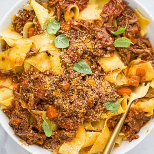 Overhead view of braised short rib ragu served over pappardelle