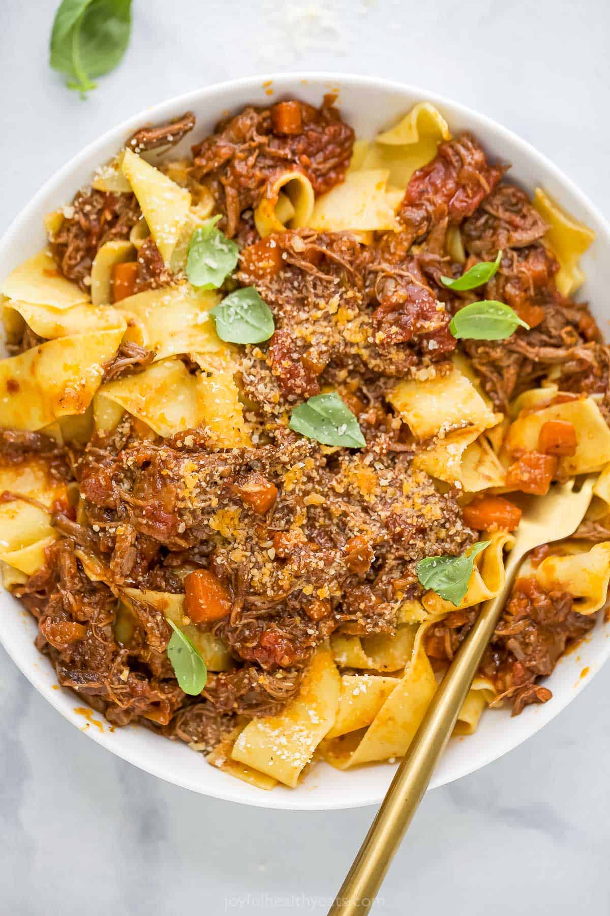 Overhead view of braised short rib ragu served over pappardelle