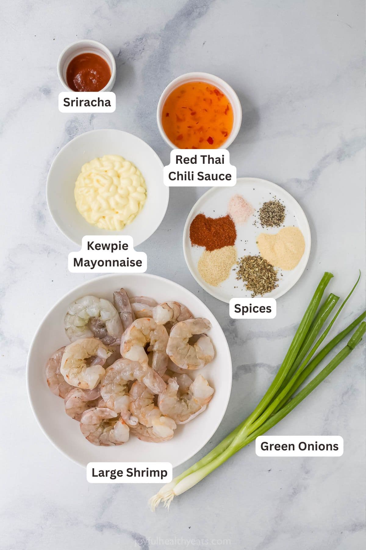 The air fryer makes this crispy Bang Bang Shrimp recipe super easy and lighter, and a creamy, spicy sauce makes it irresistible! Overhead view of ingredients for bang bang shrimp recipe
