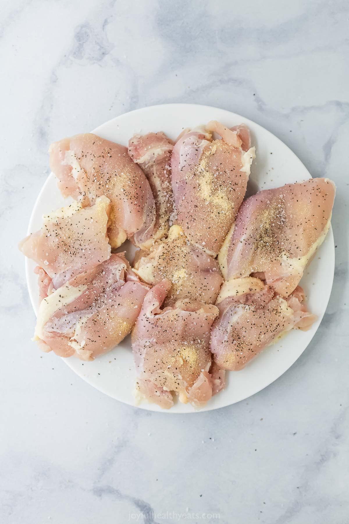 Seasoned chicken thighs on plate