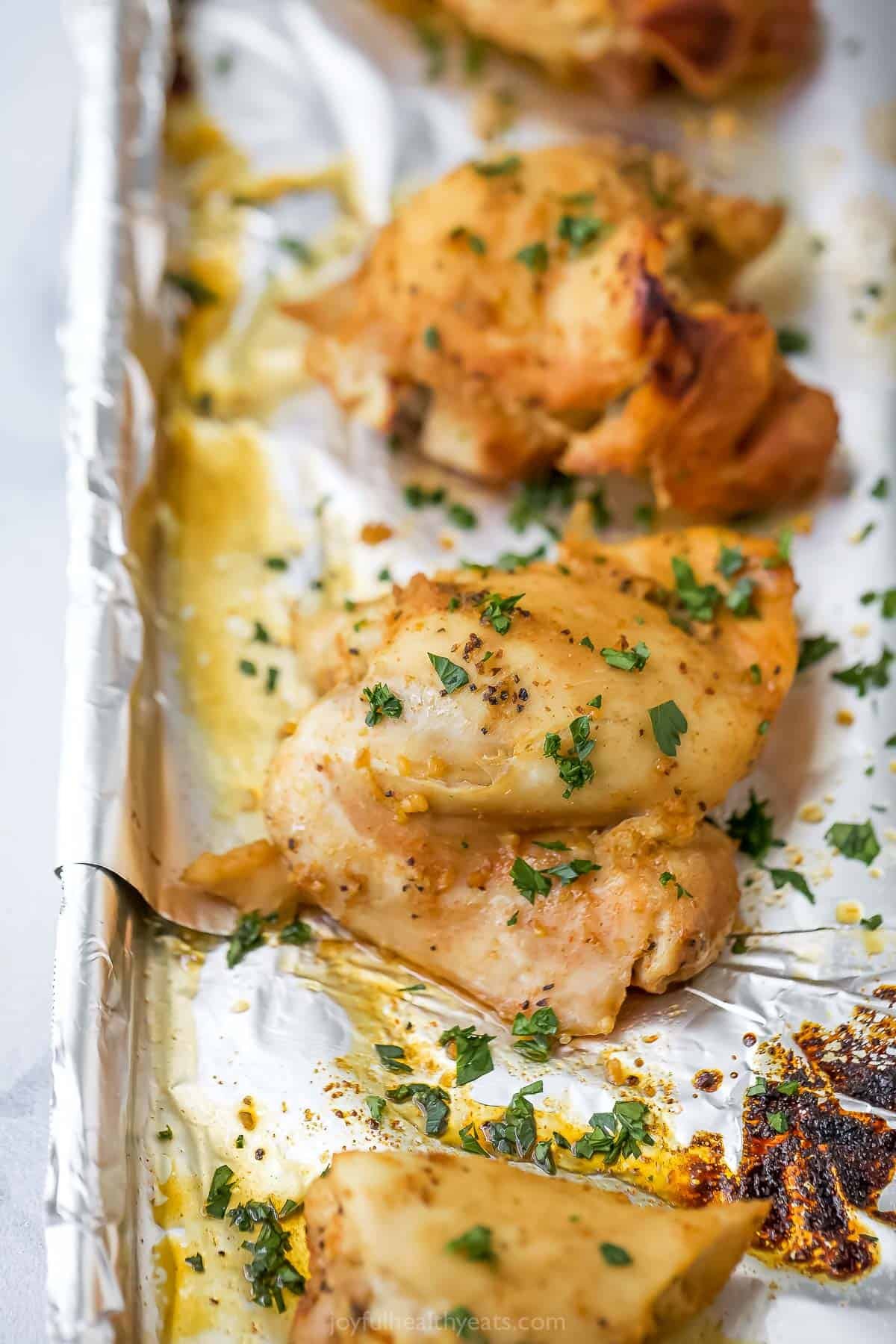 Broiled slow cooker chicken thighs on foil-lined sheet pan