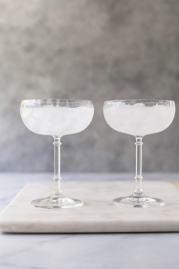 With the sweet, delicate flavor of pears and elderflower, this Pear Martini tastes fancy but it’s super easy to make at home! Two martini glasses filled with ice and water.