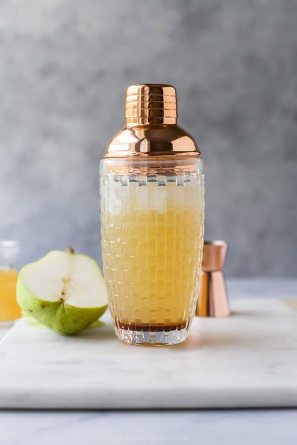 With the sweet, delicate flavor of pears and elderflower, this Pear Martini tastes fancy but it’s super easy to make at home! Cocktail shaker with pear martini ingredients inside.