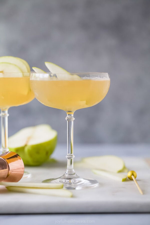Two pear martinis on marble board.