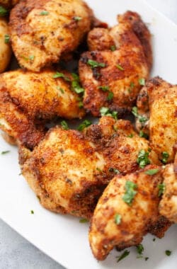 Platter of crispy air fryer chicken thighs.