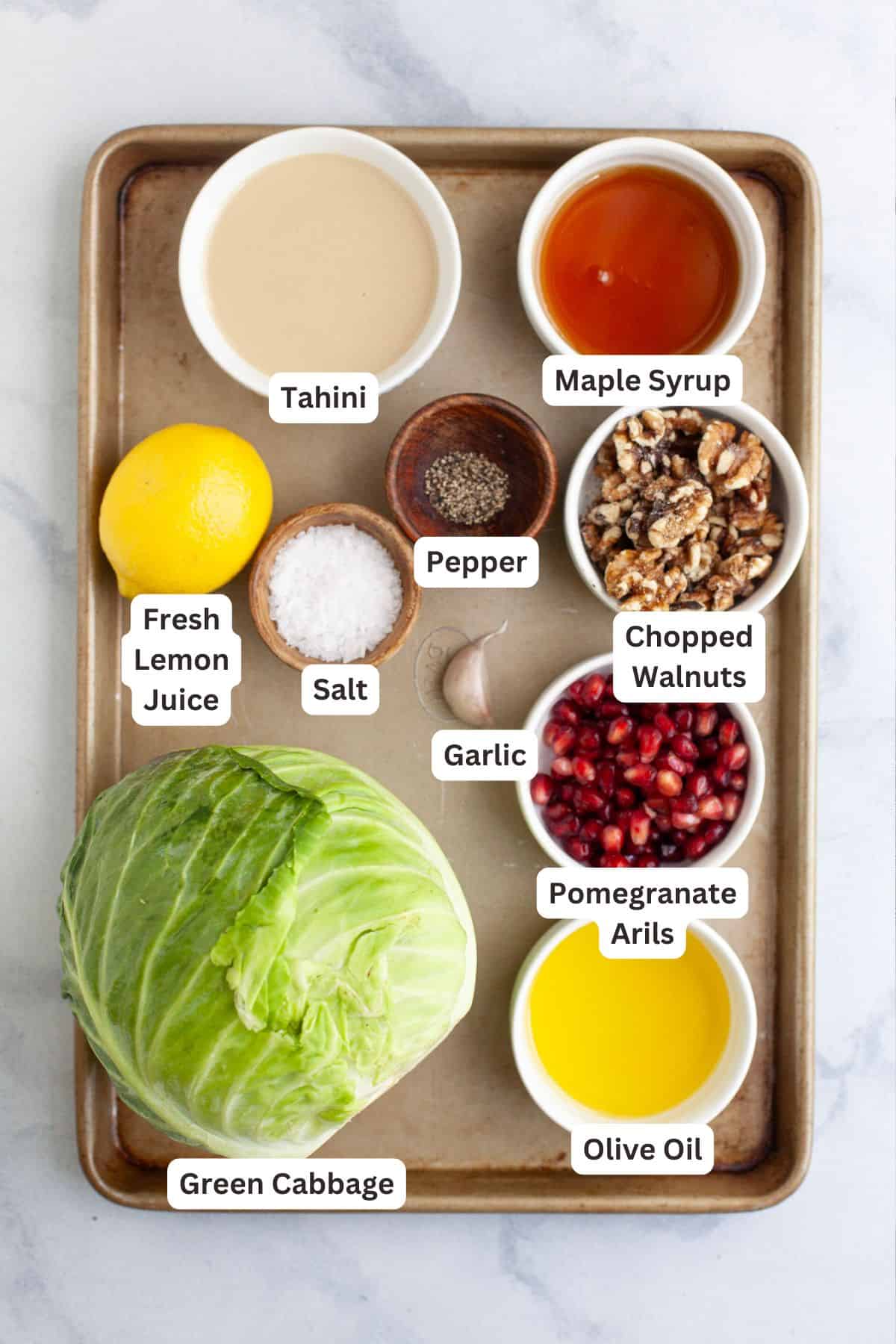 Ingredients for blistered cabbage steaks with maple tahini and pomegranate.