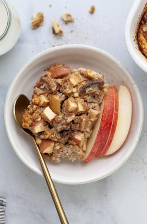 Bowl of cinnamon baked apple oatmeal with spoon.