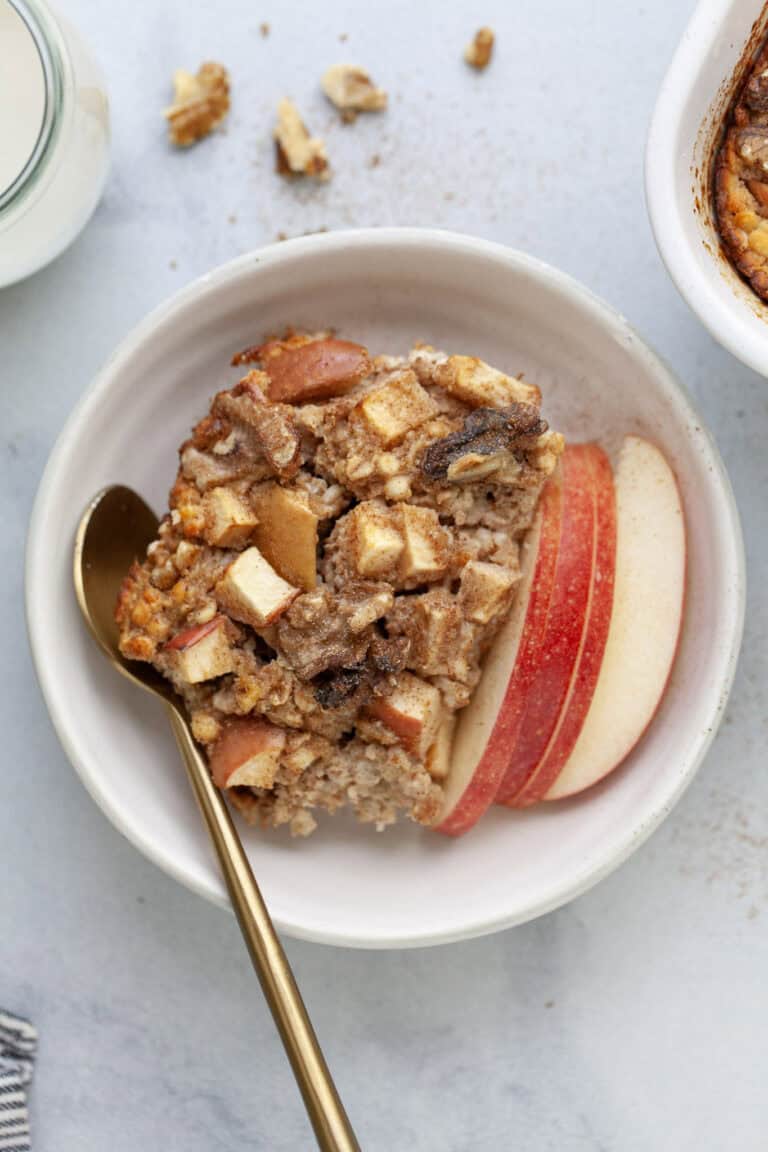 Bowl of cinnamon baked apple oatmeal with spoon.