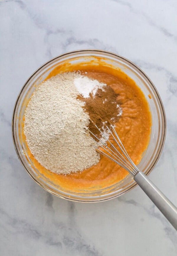 Dry ingredients added to pumpkin protein muffin batter.