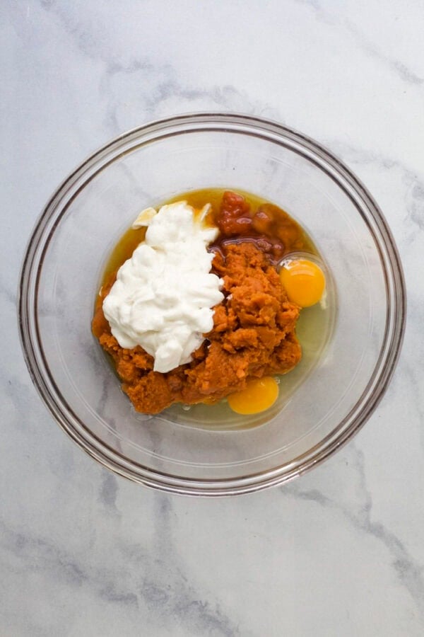 Wet ingredients for pumpkin protein muffins in bowl before mixing.